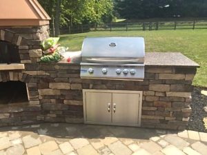 outdoor kitchen with brick oven fireplace with grill